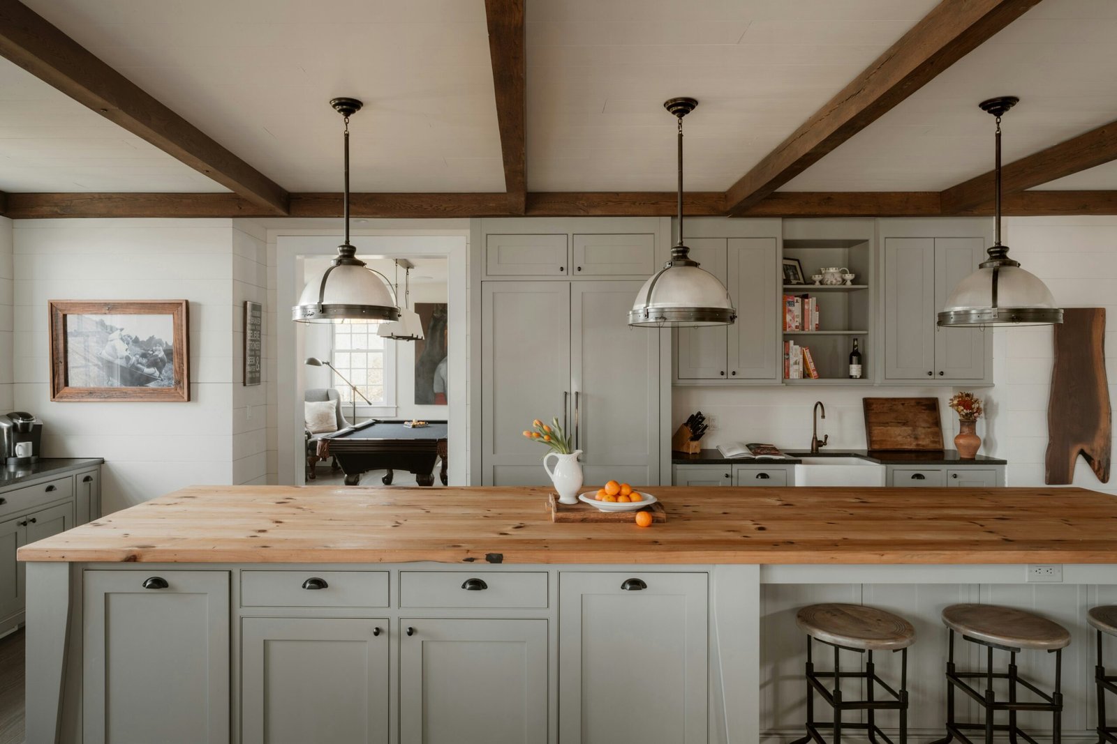 Modern farmhouse kitchen with warm neutral cabinets painted in soft greige and natural wood island top, featuring timeless cabinet color trends for 2026 in kitchen design.
