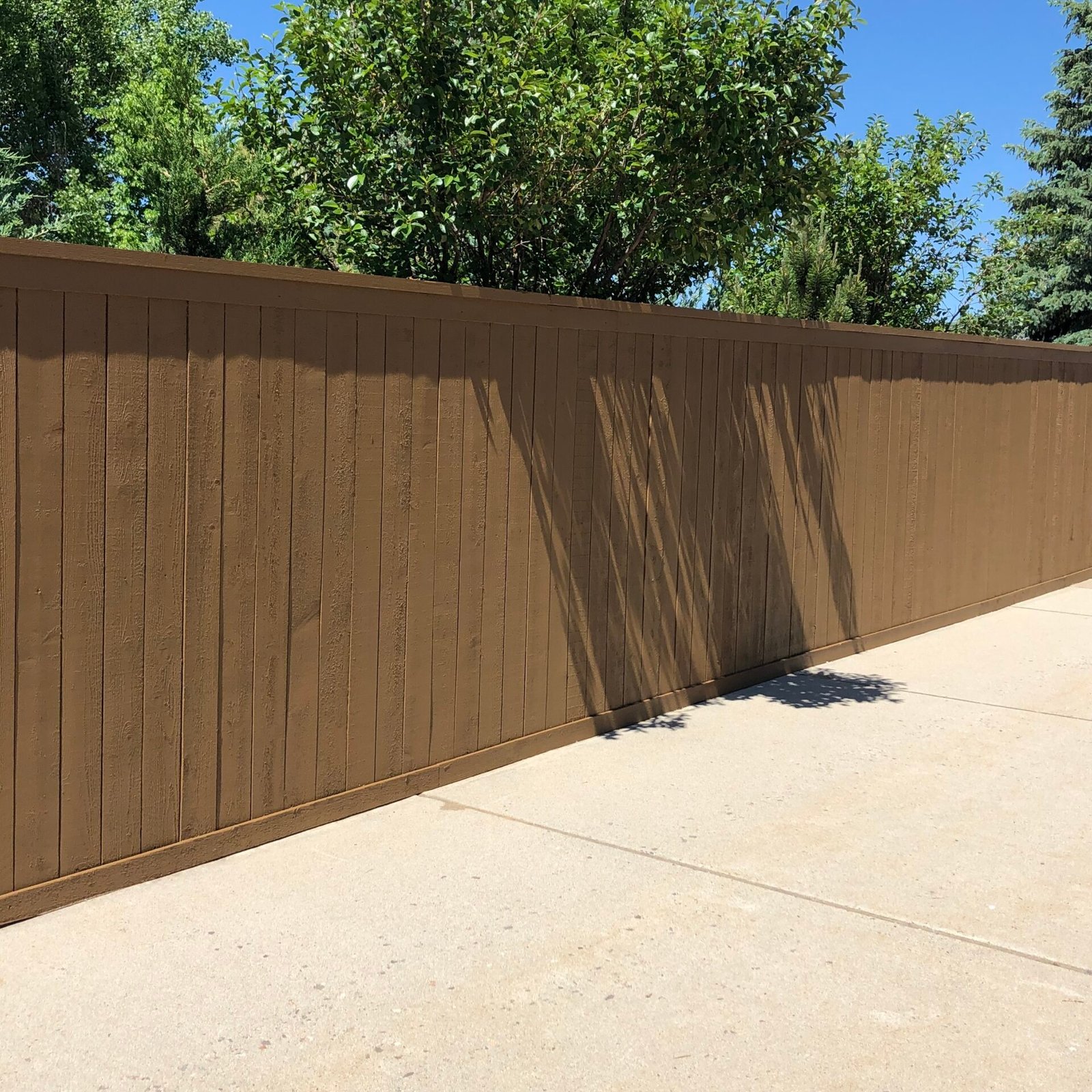 Commercial business fence that's stained by Paint EZ crew.