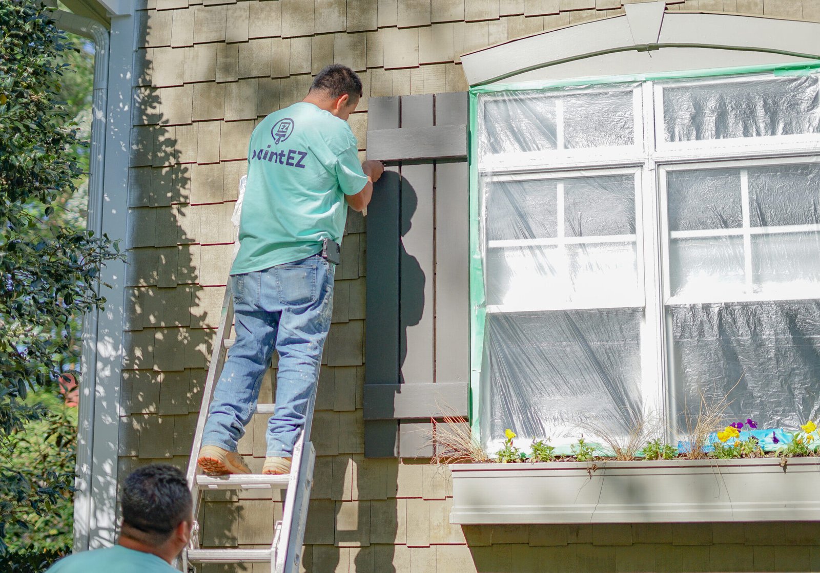 Paint EZ technicians pressure washing and prepping home surfaces