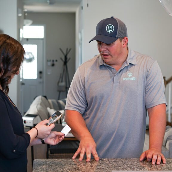 Paint EZ area manager consulting with with a customer.