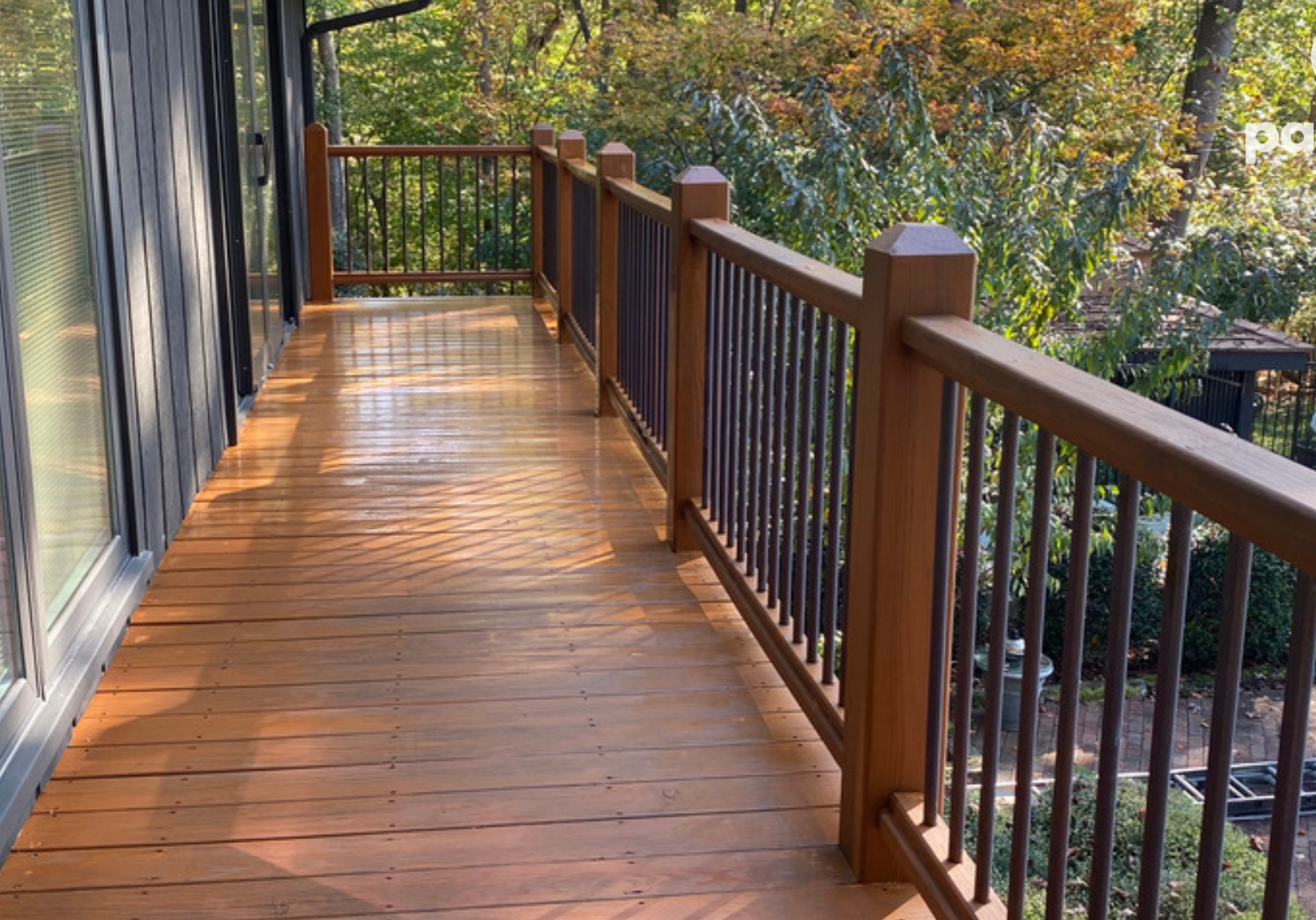 Freshly stained wooden deck by Paint EZ – professional deck and fence staining services that protect and enhance outdoor wood surfaces.