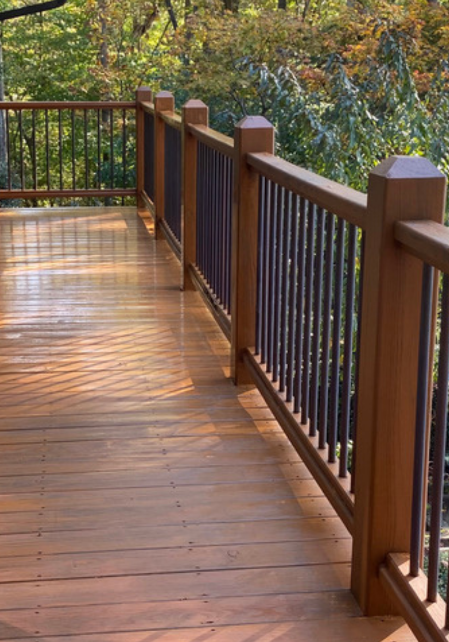 Freshly stained wooden deck by Paint EZ – professional deck and fence staining services that protect and enhance outdoor wood surfaces.