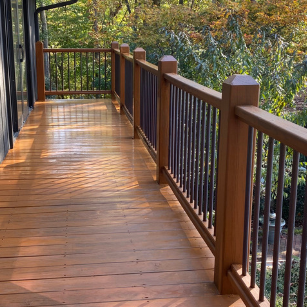 Freshly stained wooden deck by Paint EZ – professional deck and fence staining services that protect and enhance outdoor wood surfaces.