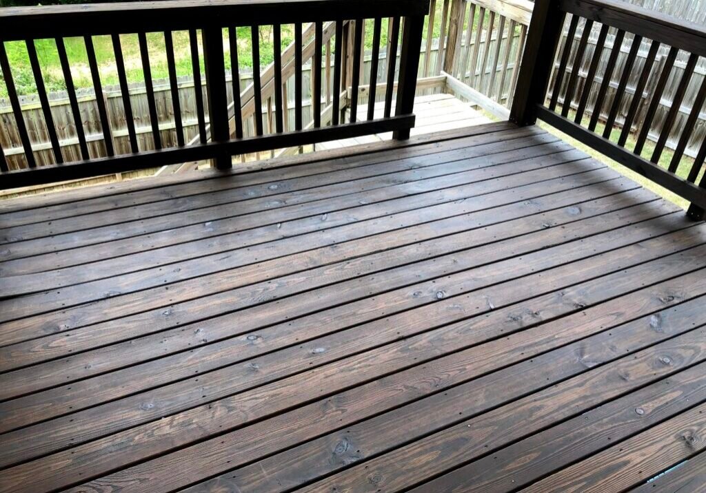 Freshly stained wooden deck by Paint EZ – professional deck and fence staining services that protect and enhance outdoor wood surfaces.