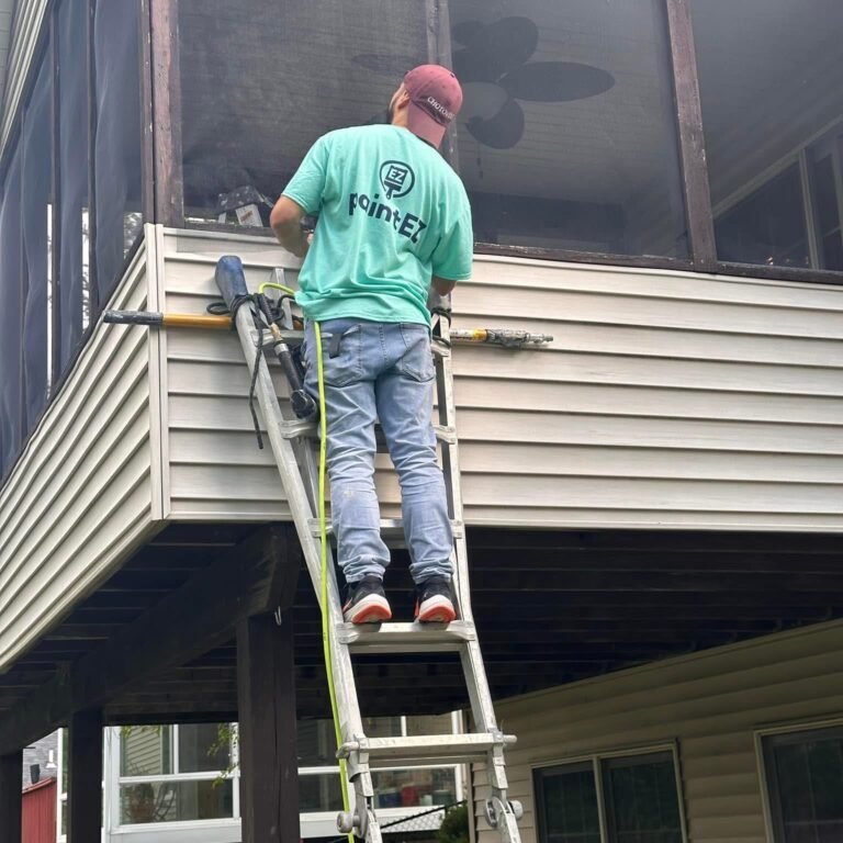 Paint EZ sanding and prepping the wood on a home exterior before painting.