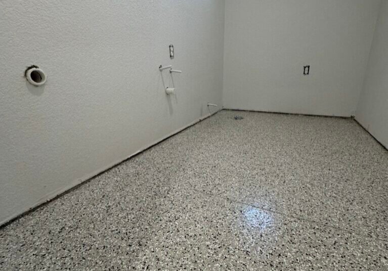 Polyspartic floor coating installed in a storage room by Paint EZ crew.