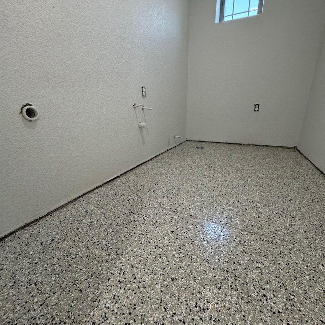 Close-up of decorative flake or metallic finish floor for commercial space completed by Paint EZ