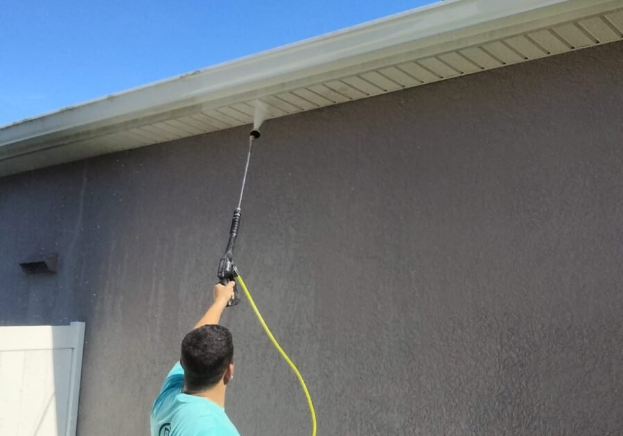 Paint EZ pressure washing outside of a home to prepare for exterior painting.