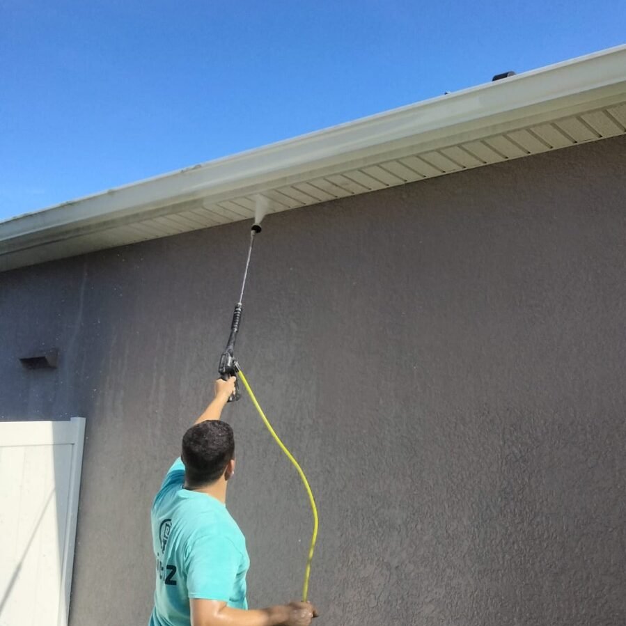 Paint EZ pressure washing outside of a home to prepare for exterior painting.