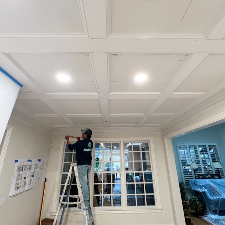 Seams around interior windows getting caulked and primed for painting by the Paint EZ crew.