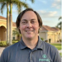 Photo of Shawn Young, area manager of Paint EZ of Clearwater. Background is home in the Clearwater area with palm trees.