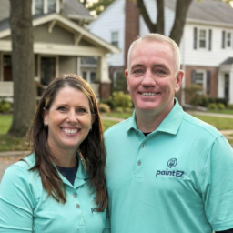 Photo of a couple in front of suburban homes in northwest Indiana. Couple is Tim and Stacie Savage of Paint EZ.