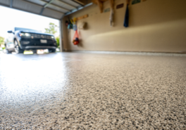 Durable epoxy or polyaspartic garage floor coating by Paint EZ – professional garage floor services that protect and enhance concrete surfaces with long-lasting, polished finishes.