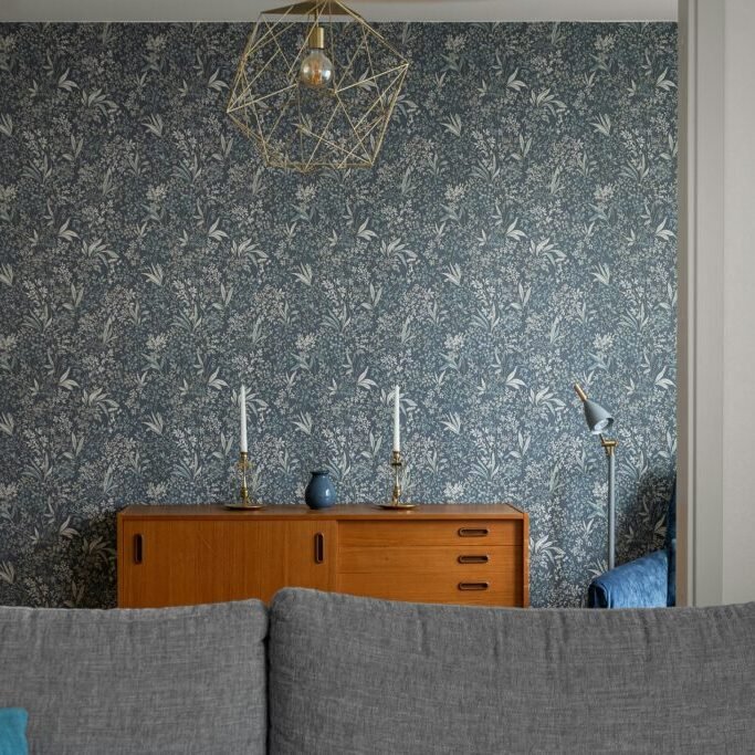 Floral wallpaper accent wall installed by Paint EZ, featuring seamless pattern alignment in a modern living room.
