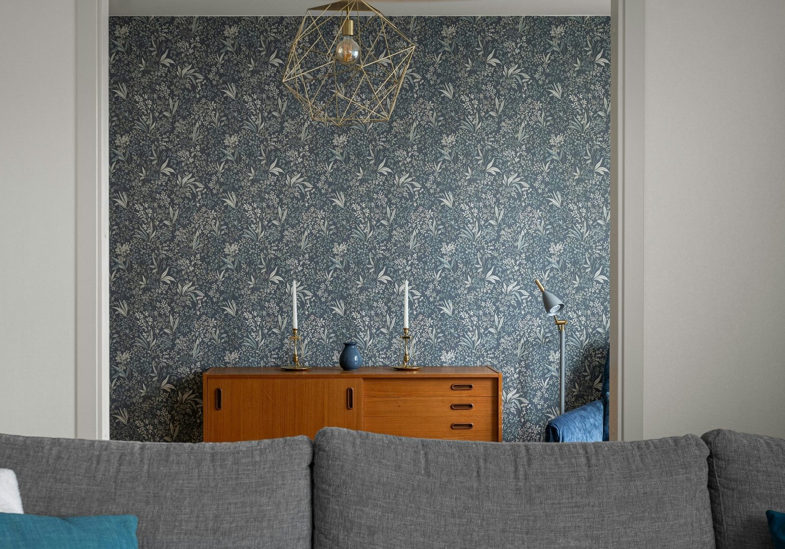 Floral wallpaper accent wall installed by Paint EZ, featuring seamless pattern alignment in a modern living room.