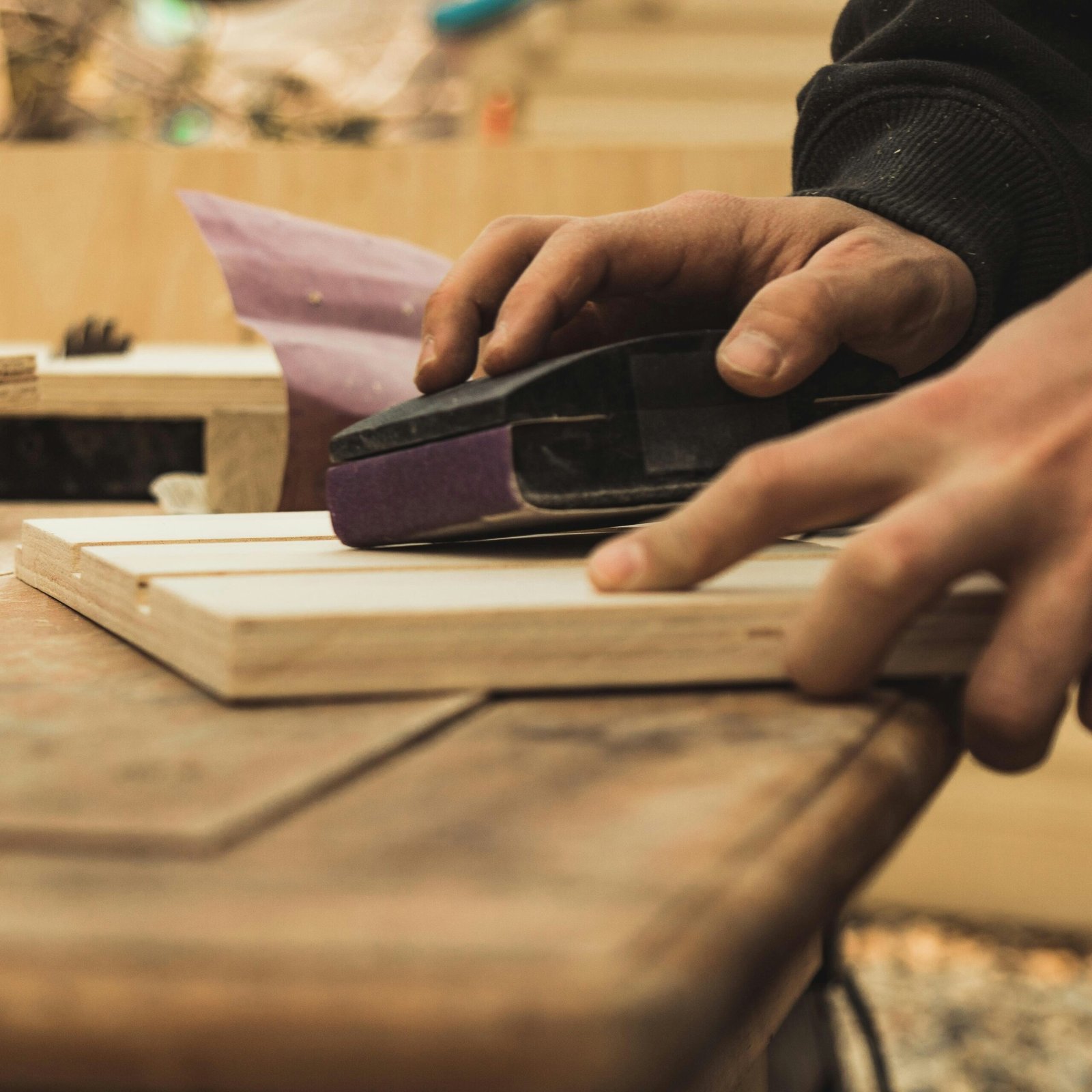 Paint EZ expert sanding trim and baseboards during carpentry repair