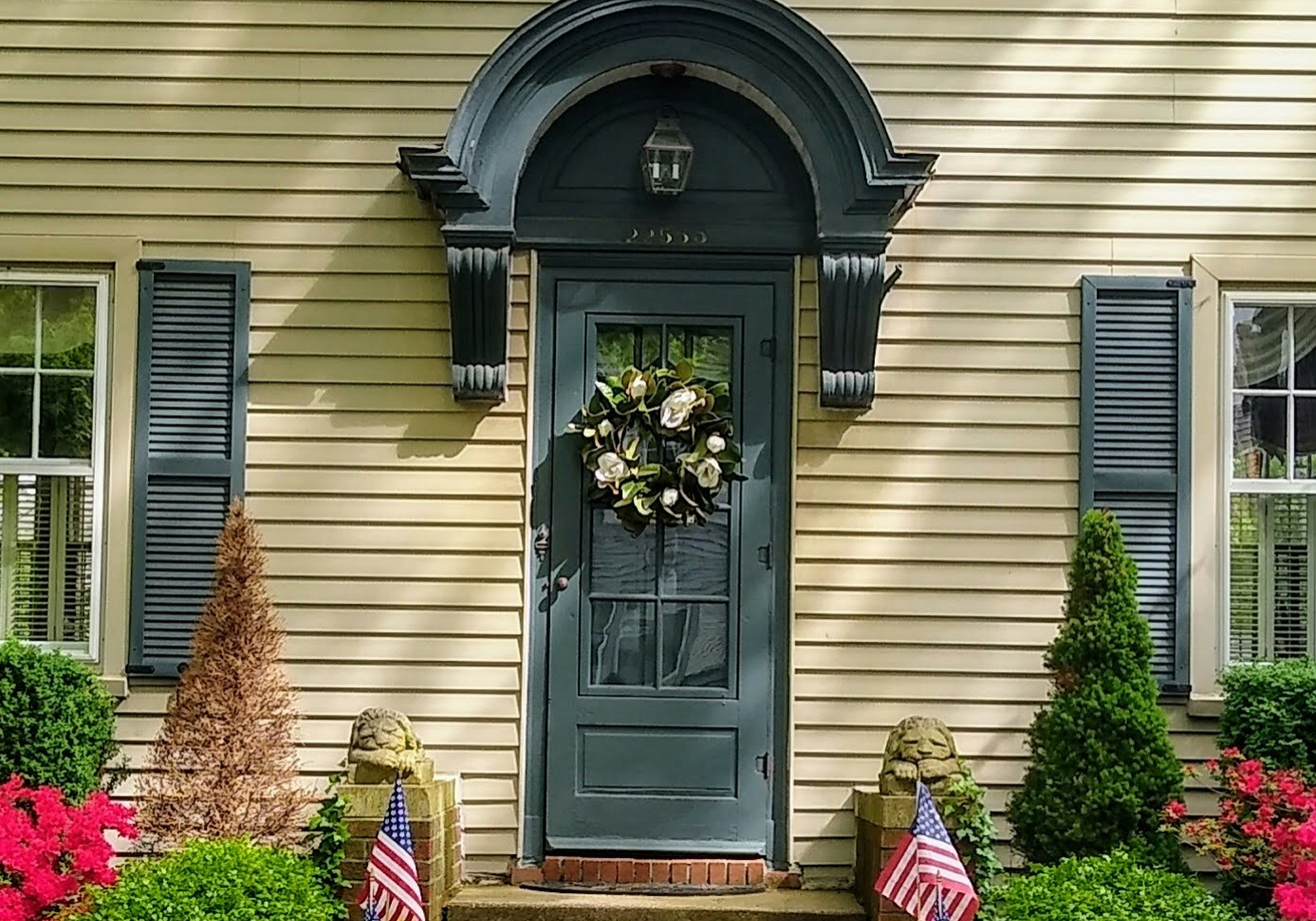 Exterior front door and shutters painted in black.