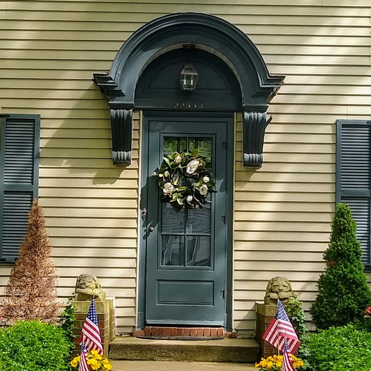 Exterior front door and shutters painted in black.