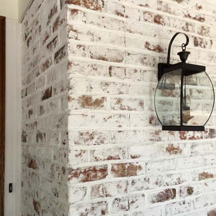 German schmear brick exterior featuring white mortar wash with exposed red brick accents