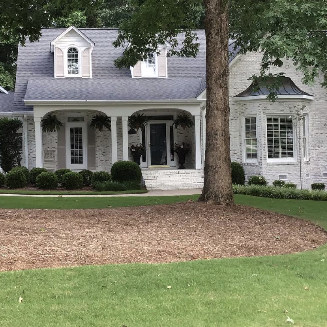 Exterior brick home that was lime washed by Paint EZ crew.
