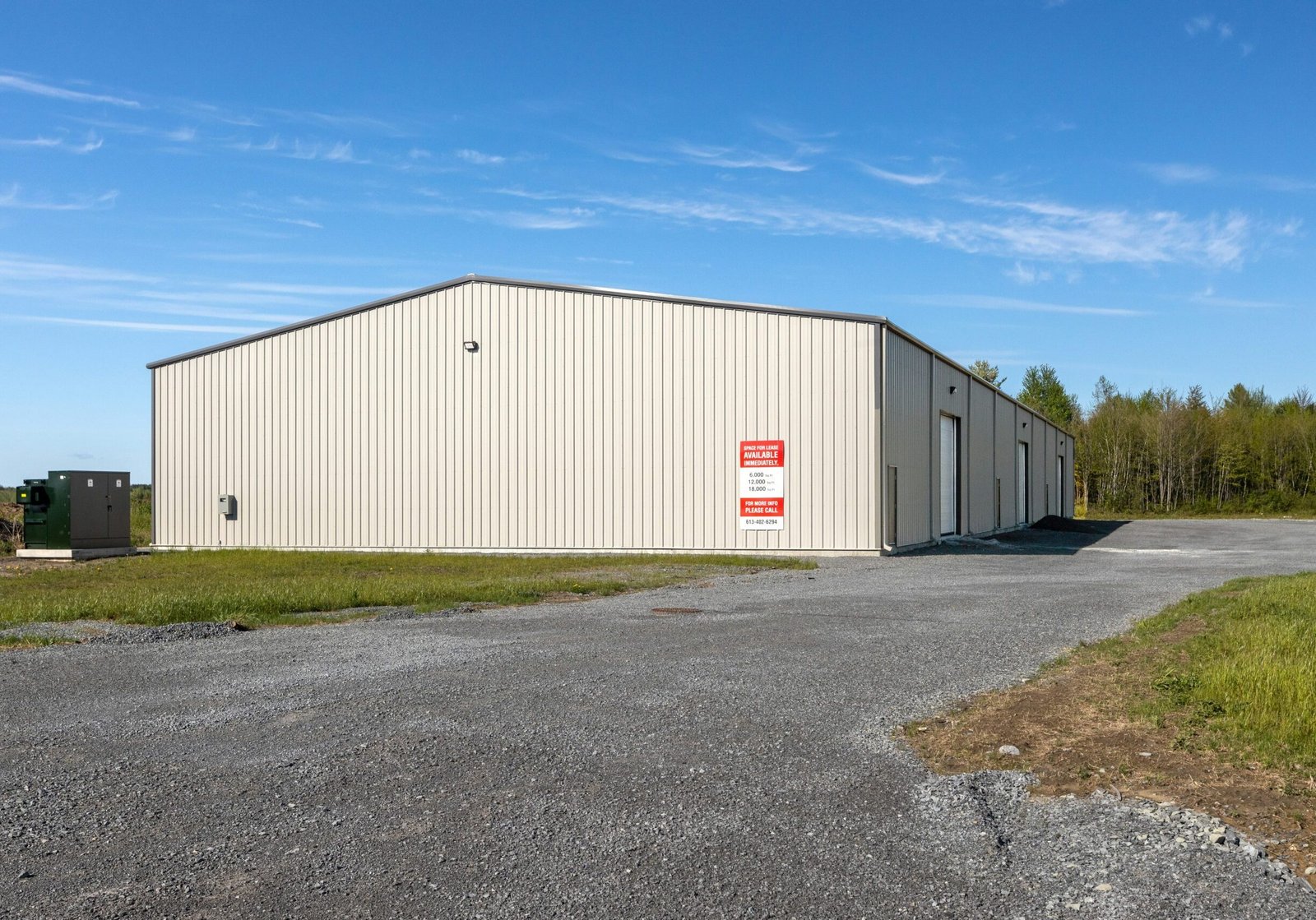Large warehouse exterior with painted metal surfaces, and durable industrial finishes for commercial facilities.